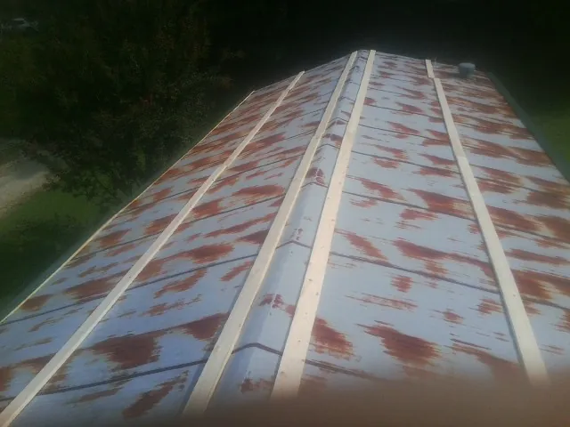 Rusted metal roof panels with new wood purlins before replacement — Storm Damage Roof Repair in Weber City by Roofing Brothers
