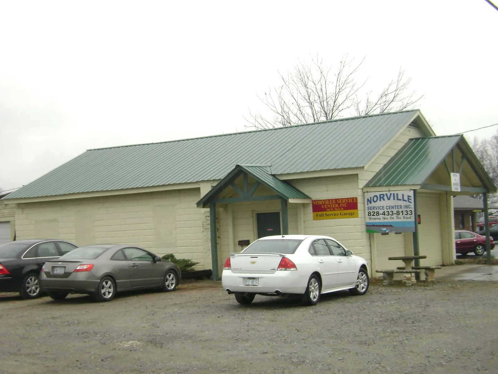 Green metal roof on a service garage with a covered entry in Weber City